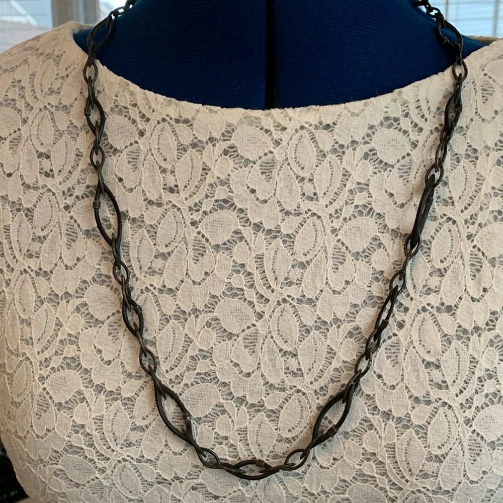 Blackened silver and wood chain with oval links in varied sizes. 14” long.
